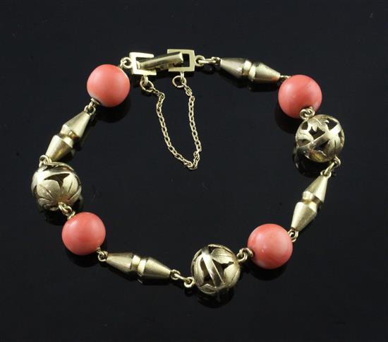 A high carat gold and coral bead bracelet, approx. 7in.